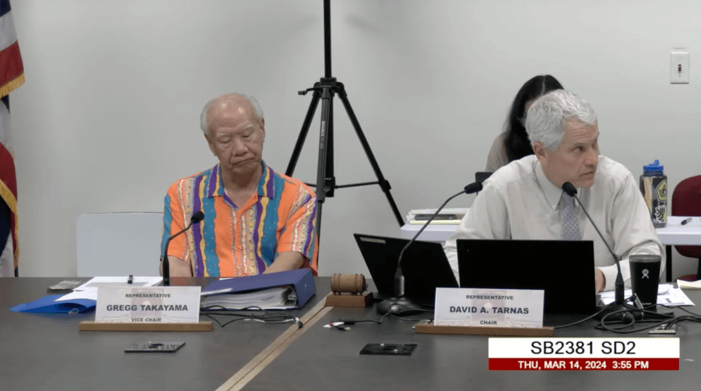 Reps. Gregg Takayama (left) and David Tarnas during a hearing where a bill to create comprehensive public financing of Hawaii elections died. House Speaker Scott Saiki said he personally supports publicly funded elections, but deferred to the wishes of his fellow House members on the issue. (Screenshot/2024)
